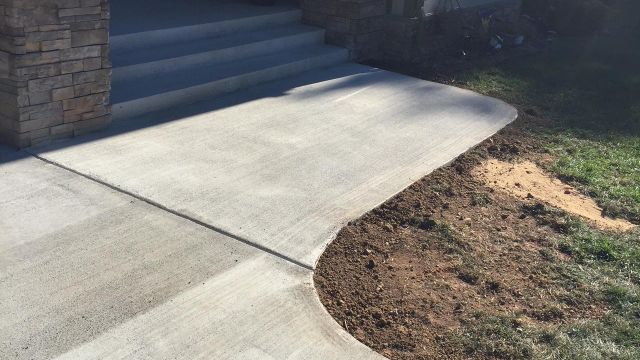 Concrete Driveway, Sidewalk, Concrete Patio with Brick Borders, Retaining Wall in Springfield VA - Wright's Concrete